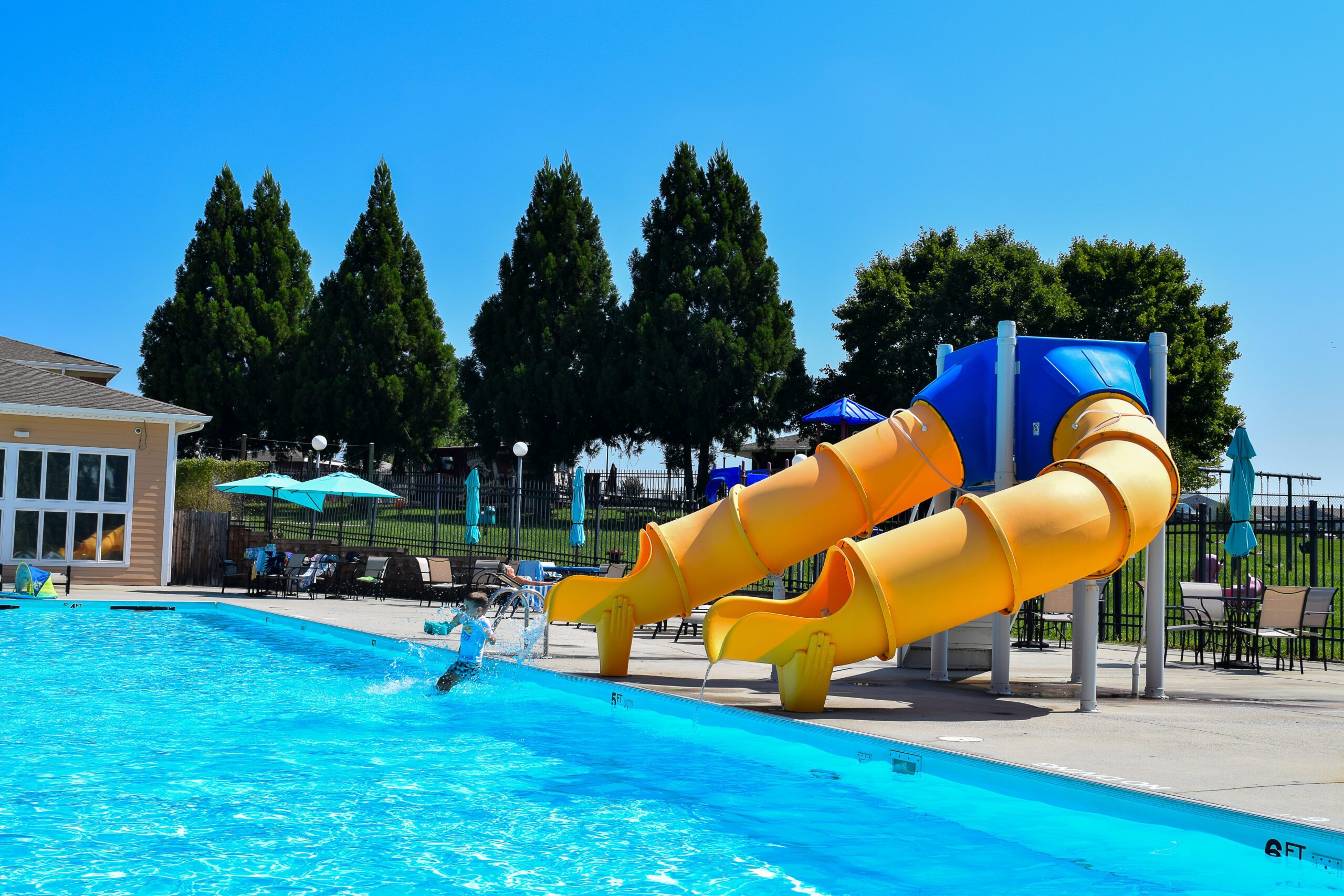 Child playing on the water slide at The Centre Outdoor Pool.